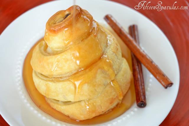 Poached Pears Wrapped in Puff Pastry - With Sauce Drizzled Down and Cinnamon Sticks