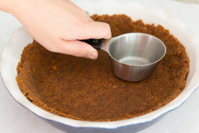 Pressing Gingersnap Cookie Crust into Pie Plate with Cup