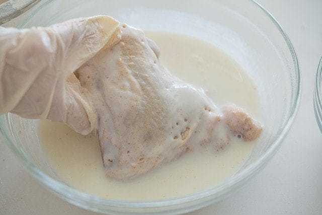 Dipping Raw Chicken Into Buttermilk 