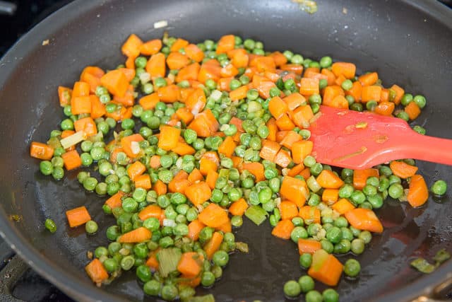 Peas and Carrots Cooking in a Skillet