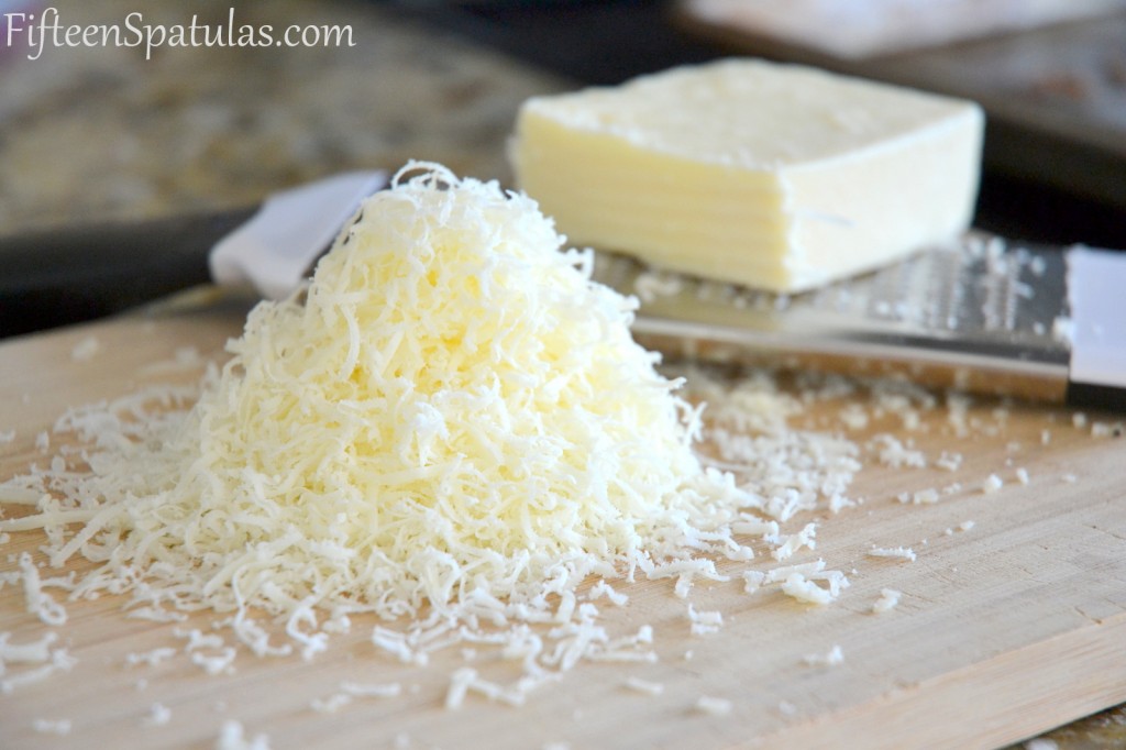 Pecorino Cheese Grated on Cutting Board