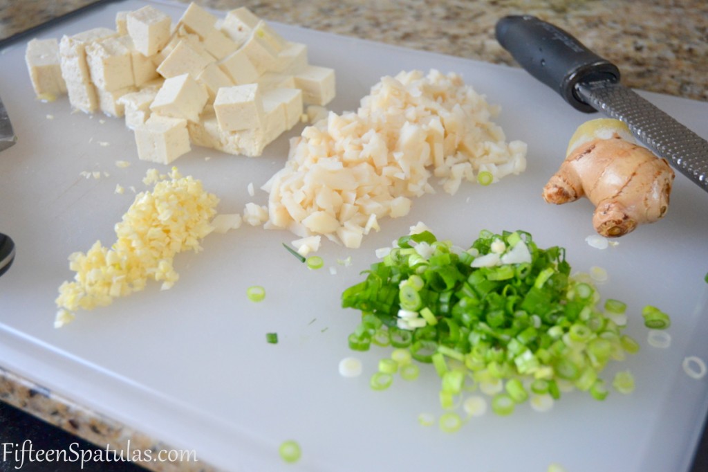 Asian Pork Lettuce Wraps Ingredients on Cutting Board - Tofu, Scallions, Water Chestnuts, Ginger
