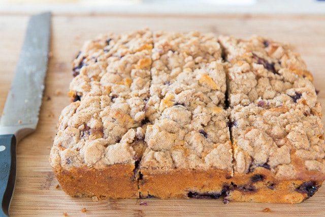 Fully Baked Blueberry Buckle on Wooden Board Cut Into Squares
