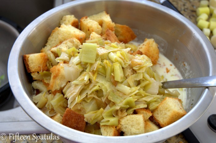 Mixing Bowl with Custard Liquid, Toasted Brioche Bread Cubes, and Softened Leeks