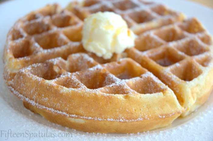 Crispy Waffle - On a Plate with a mound of Butter and Dusted with Powdered Sugar