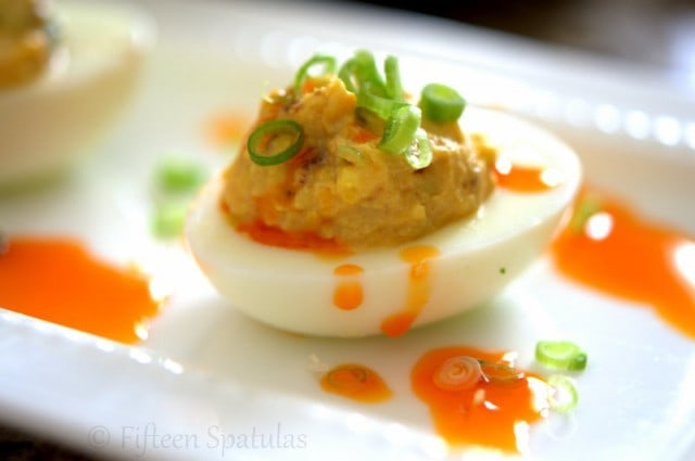 Deviled Egg on Platter with Scallions and Chile Oil