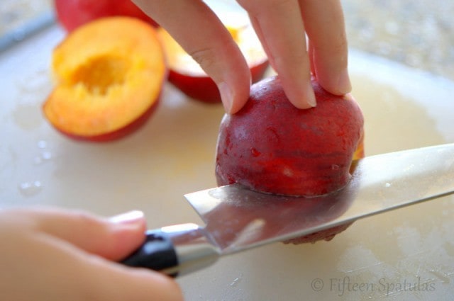 Cutting Around Peach with Knife to Remove Pits
