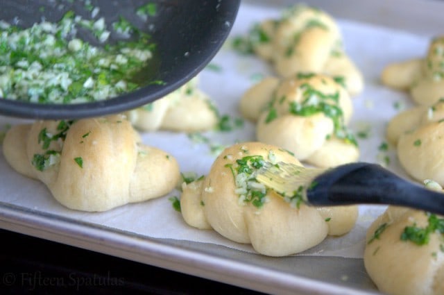 Brushing Garlic Parsley Butter on Freshly Baked Pizza Knots