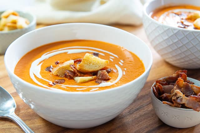 Tomato Bisque Soup Recipe - Served in White Dish with Cream Drizzle and Croutons
