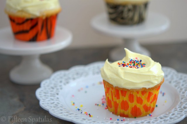 Almond Buttercream Cupcakes with Sprinkles on White Plates