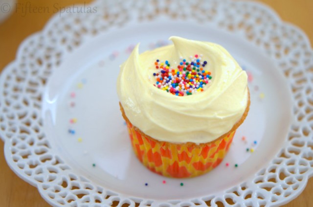 Almond Buttercream Frosting Cupcake on Plate with Sprinkles