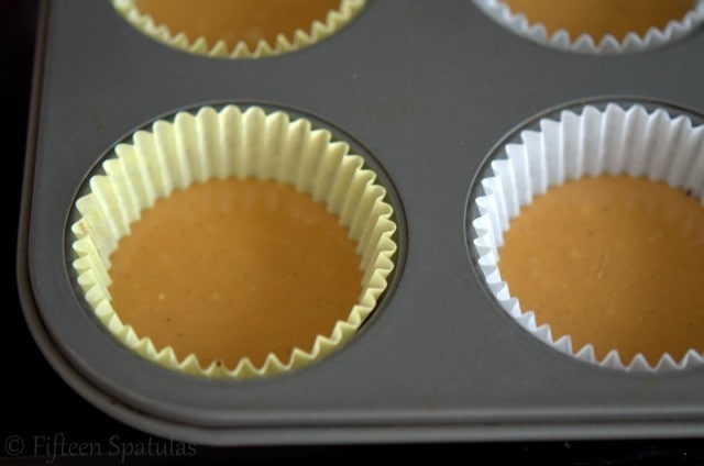 smoothed out peanut butter layers in paper muffin wells
