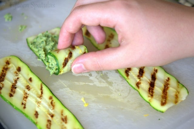 Rolling Up the Zucchini Filled with Pesto