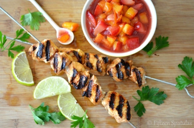 Yogurt Marinated Grilled Chicken on Skewers with bowl of Chutney on Side