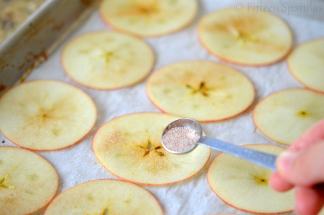 Sprinkling Apple Chips with Cinnamon sugar