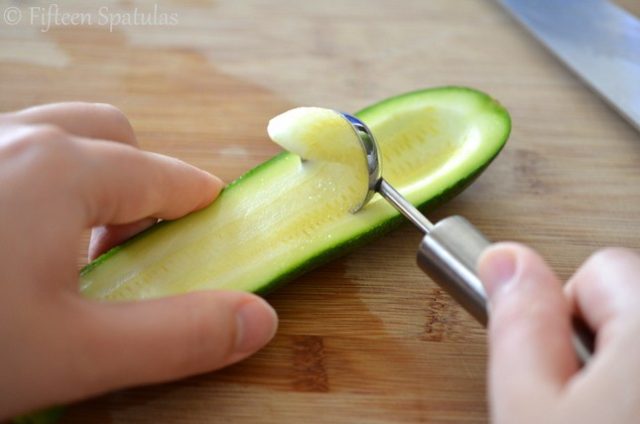 Using a Melon baller to Scoop Out Zucchini Seeds