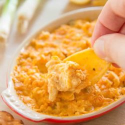 Scooping Buffalo Chicken Dip with a Frito Chip