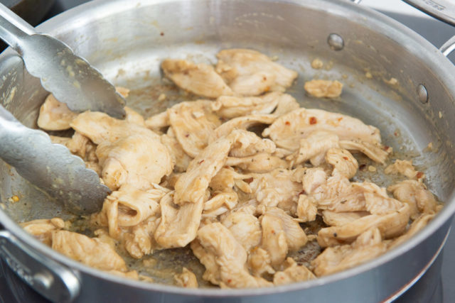Mostly Cooked Thinly Sliced Chicken Breast in Skillet