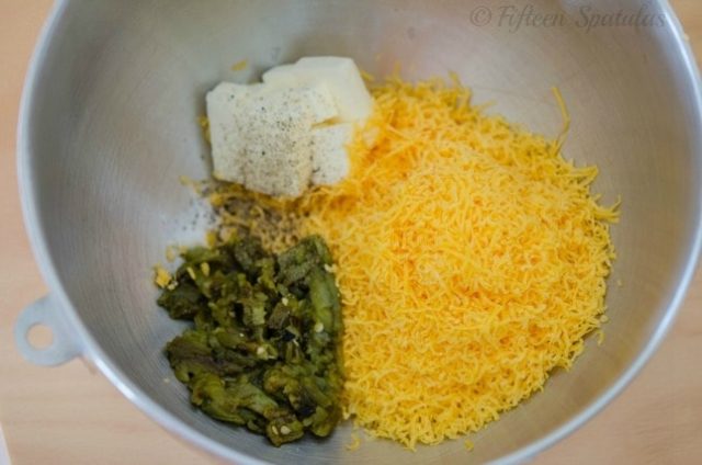 cheddar cheese, butter, and charred chiles in mixing bowl