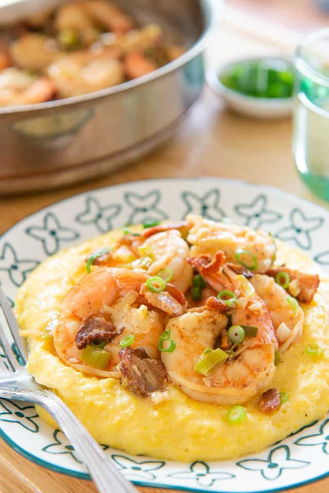 Shrimp and Grits Recipe - Served on Blue Plate with Fork and Scallion Garnish