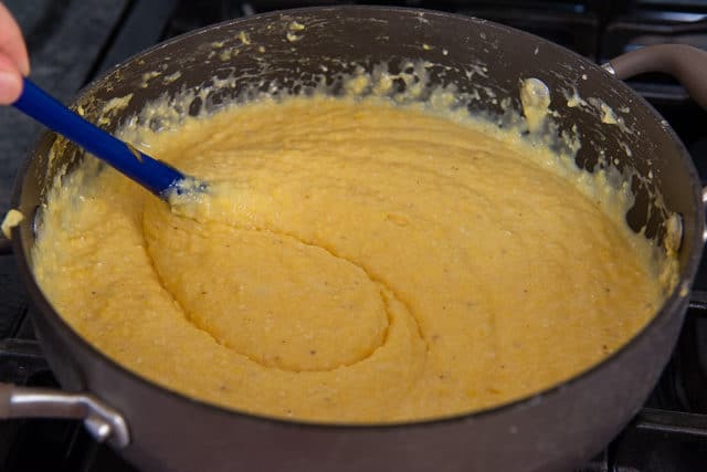 Stirring the Cheddar Cheese Creamy Grits in Pan