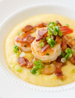 Shrimp and Grits - in White Bowl with Scallion Garnish