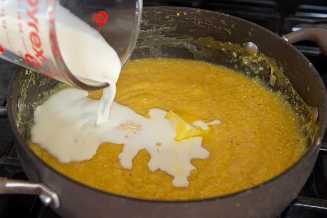 Pouring Cream into Grits in Pan