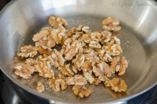 toasting walnuts in skillet to be glazed in maple syrup