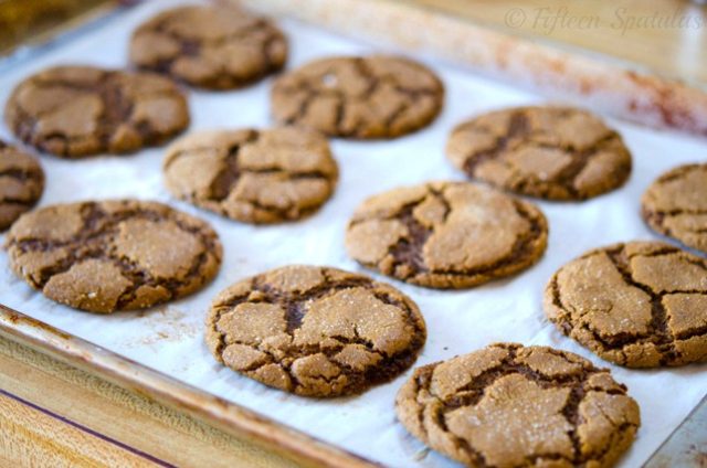chewy ginger molasses cookies baked on parchment paper