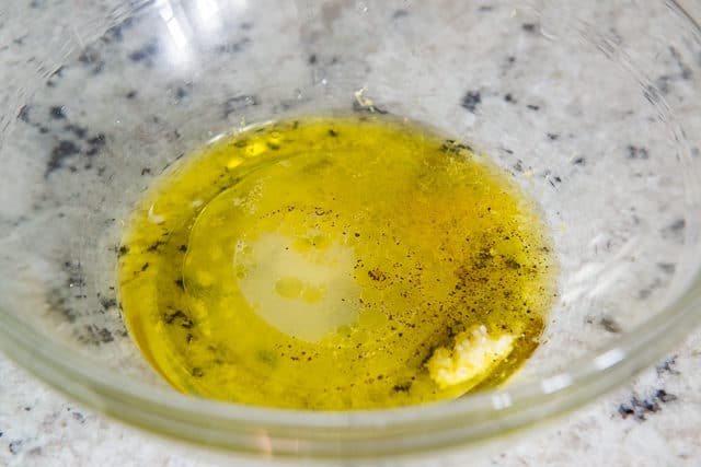 Olive Oil, Lemon, Garlic, and Seasoning in Glass Bowl