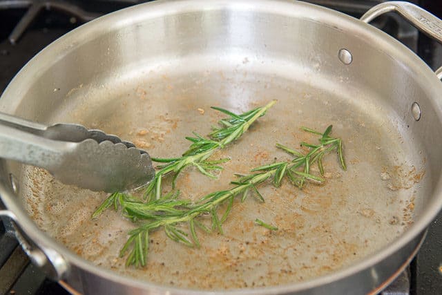 Frying rosemary in bacon fat in a Skillet 