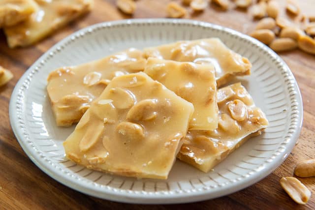 Pieces of Homemade Peanut Brittle on a Gray Plate