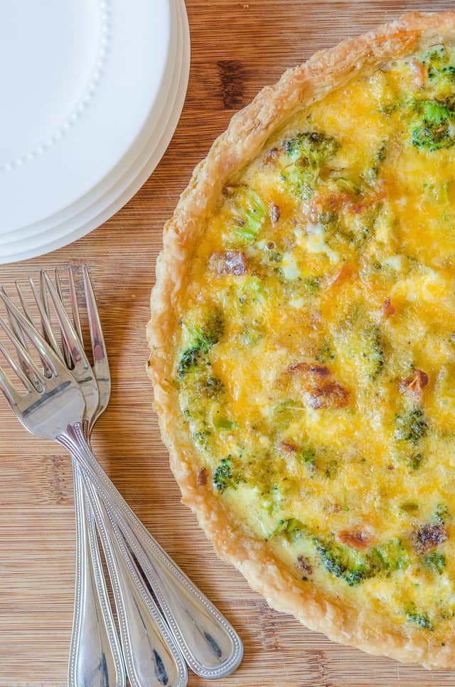 Broccoli Cheddar Quiche - Whole on Cutting Board with Forks and Plates