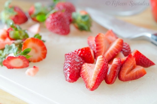 cut up fresh strawberries to be pureed for strawberry buttercream