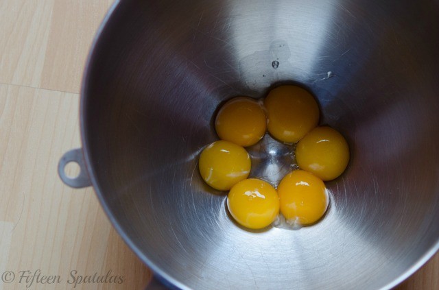 six egg yolks in a mixing bowl