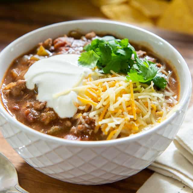 Best Turkey Chili - Served in White Bowl with Sour Cream, Cilantro, and Cheese