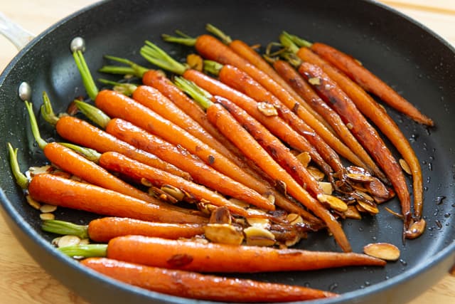 Glazed Carrots with Maple Candied Almonds in Black Nonstick Skillet - Carrot Recipes
