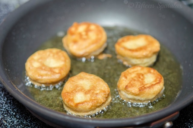 Chickpea Fritters Frying in Olive Oil in a Skillet