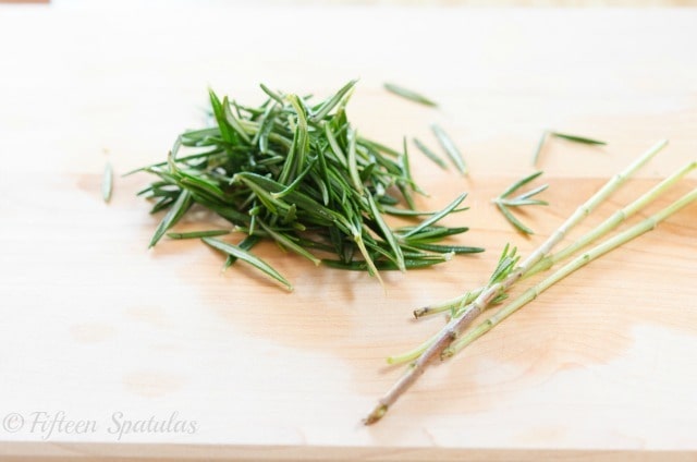 Stripped Fresh Rosemary Leaves on Cutting Board