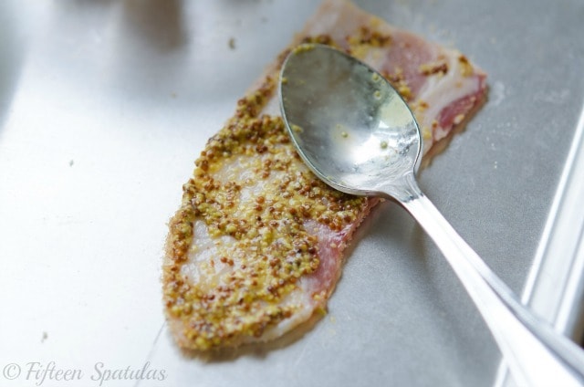 Spreading Mustard on Bacon Slice with Spoon