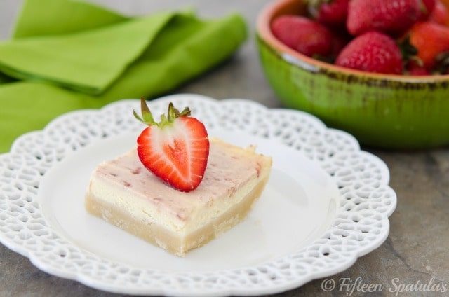 a square of strawberry swirled cheesecake shortbread crust bars