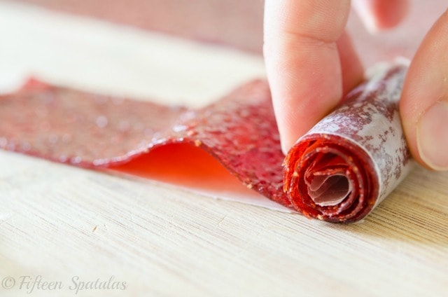 Rolling Up a Strawberry Fruit Roll Up with Fingers