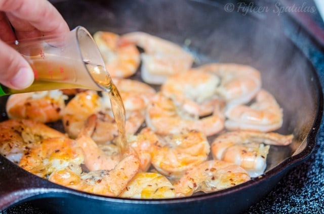 Pouring Alcohol Into Shrimp Cast Iron Pan