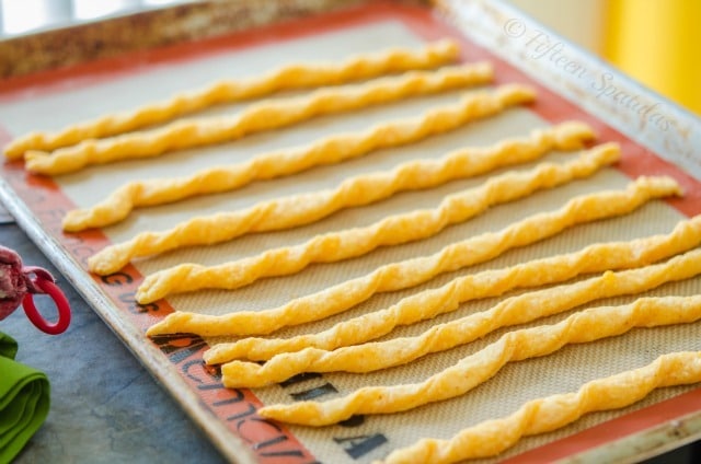 Cheese Twist Crackers - Lined up in Row on Sheet Pan