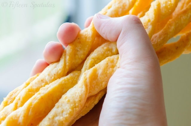 Hand Holding Cheese Twists