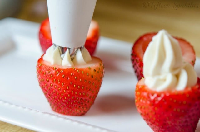 Piping the Cream Cheese Filling Into Hollowed Out Strawberries
