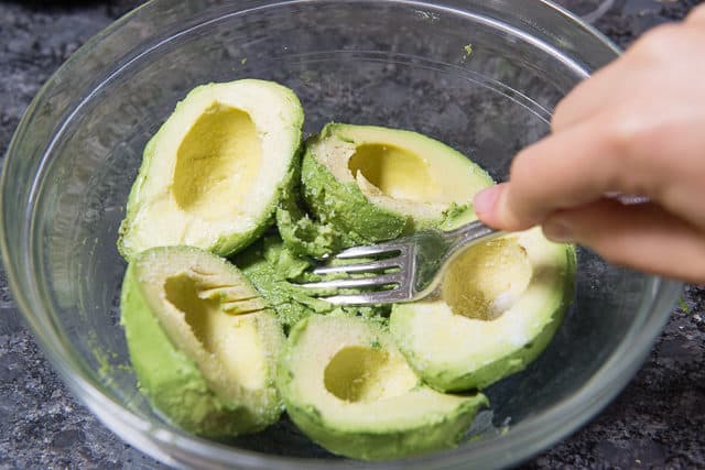 Mashing Avocados in a bowl with a Fork