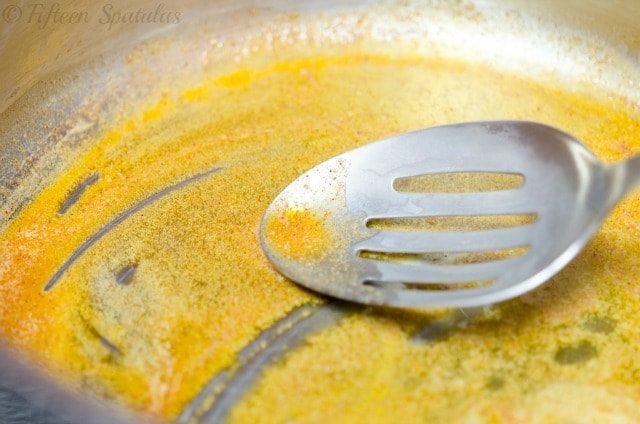 Melted butter with Spices in Saucepan with Slotted Spoon