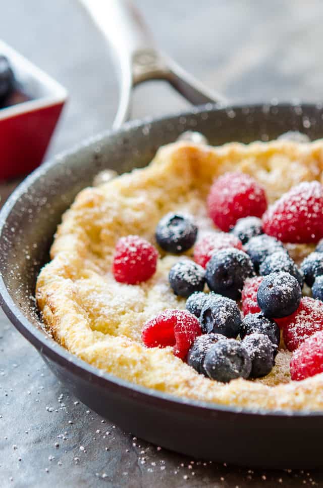 Dutch Baby Pancake - Topped with Fresh Raspberries and Blueberries in a Skillet
