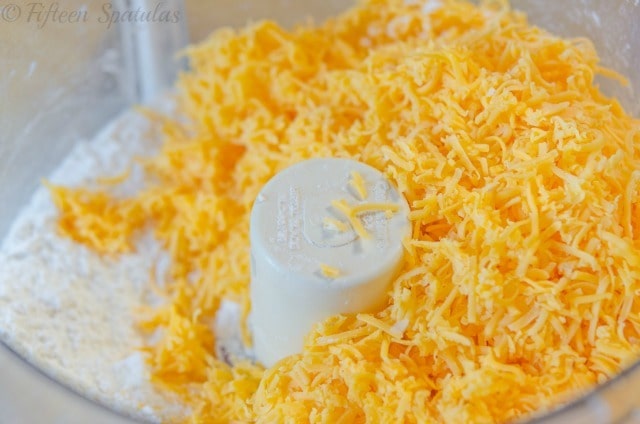 Shredded Cheddar Cheese Added to Food Processor Bowl